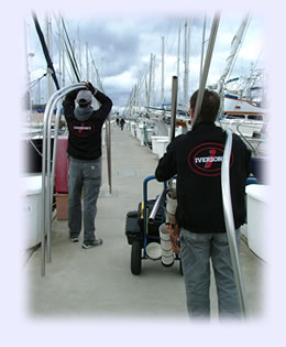 Carrying a stainless steel frame to the sailboat. Click to enlarge photo.